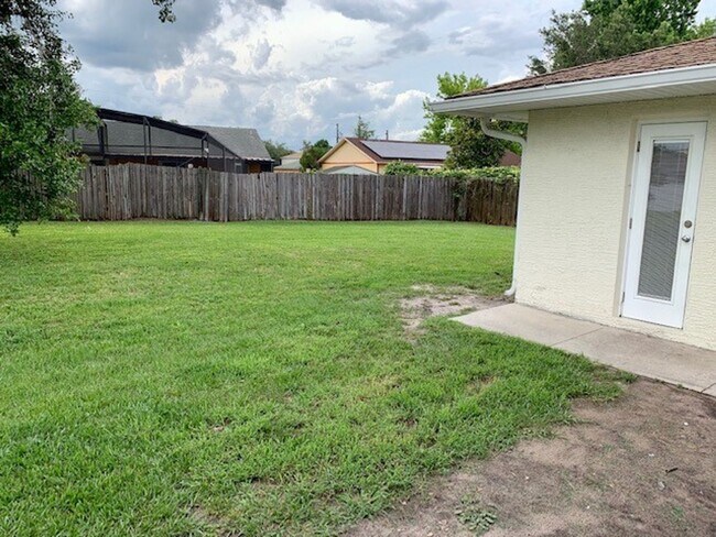 Building Photo - Available NOW! NEW FLOORS AND PAINT! Lovely 3/2 in Poinciana! HUGE fenced yard and NO CARPET!