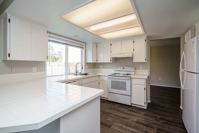 Building Photo - Recently Updated with Wood Laminate Flooring and Fresh Paint