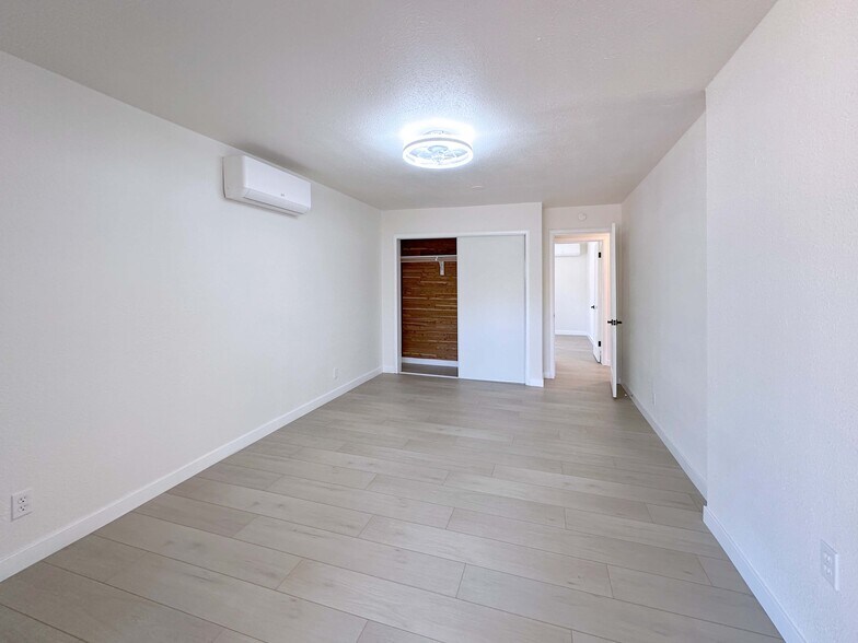 Large Bedroom #2 with ample closet space and sliding door opening to the patio. - 4570 58th St