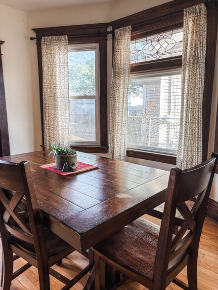 Dining room with beautiful woodwork and a leaded glass window. - 819 Edmund Ave