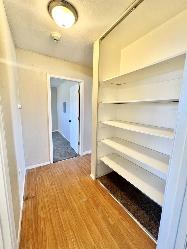 Explore the practicality of this bright hallway with ample storage space. - 1690 Eaton