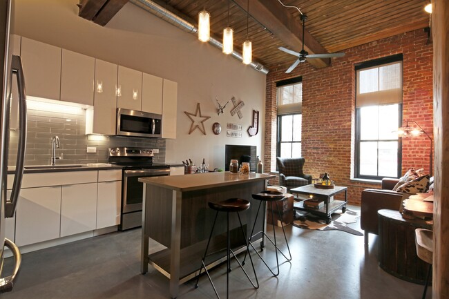 Polished Concrete Floors Throughout and Original Brick and Wood Beams Accent Apartments - Modera Lofts