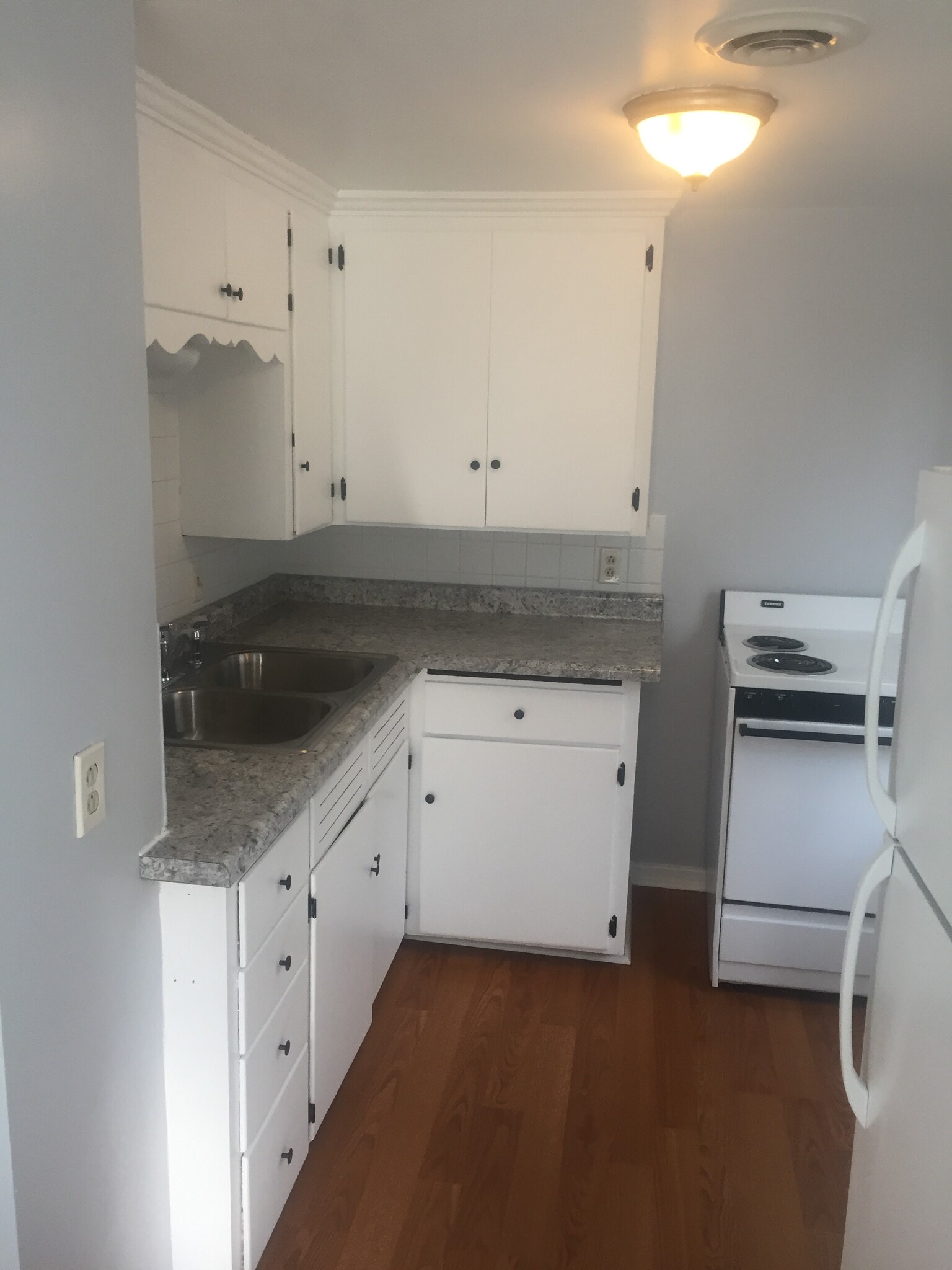 The kitchen includes a full-size refrigerator/freezer, electric stove/oven, and plenty of storage for all of your needs. - 3364 Church St