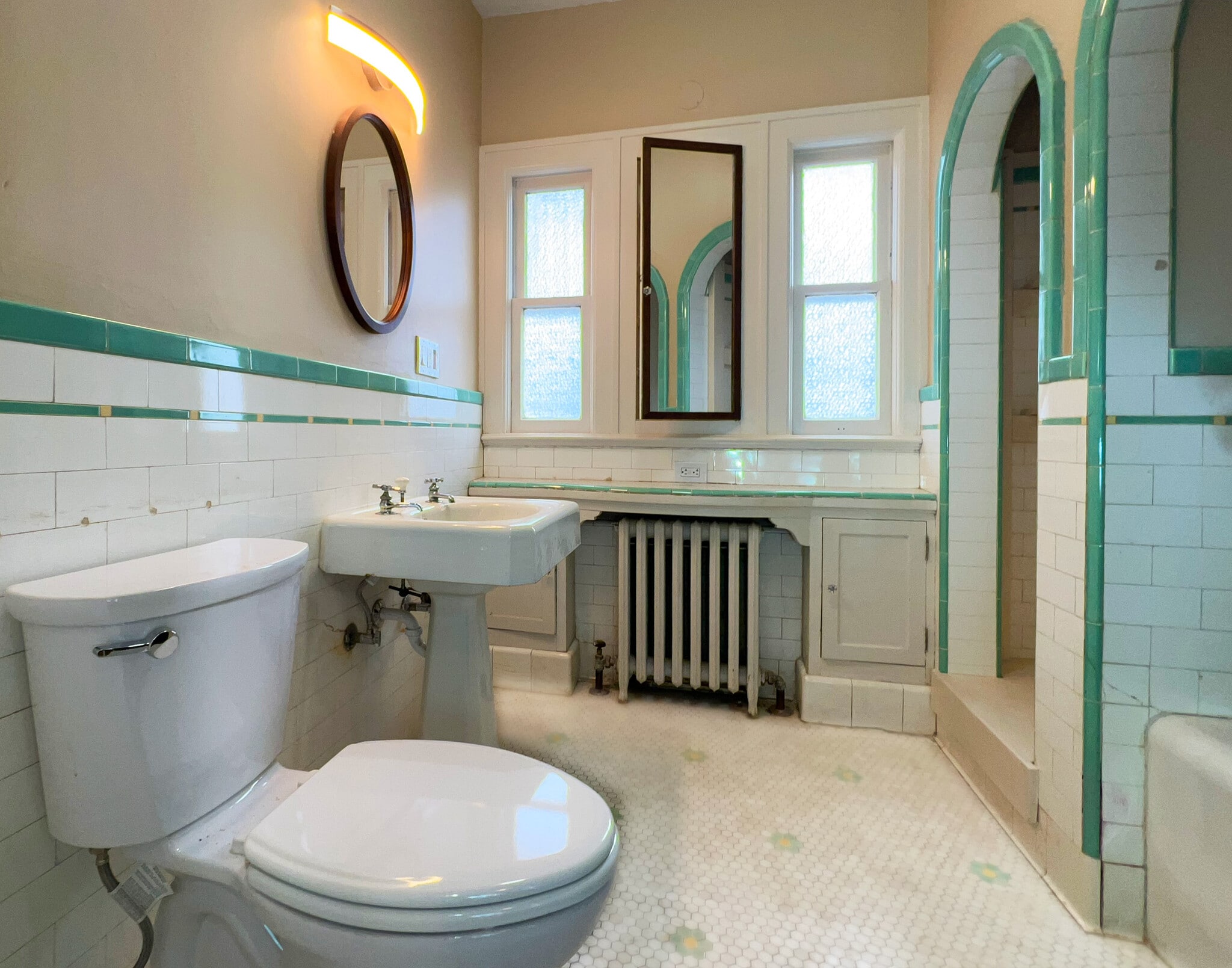 Original, vintage tiled bathroom, updated with new toilet and shower fixtures. - 3448 SW Canby St