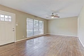 Living/dining combination w/ hardwood floors and a ceiling fan with lots of light. - 4609 Nina Lee Ln