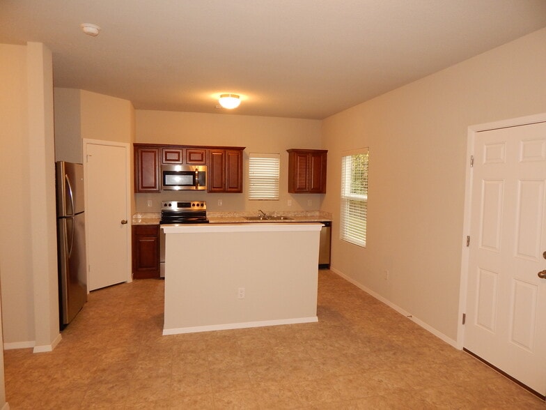 View of kitchen/dining area from living room - you'll love this great open space. - 5074 W Claxton Circle