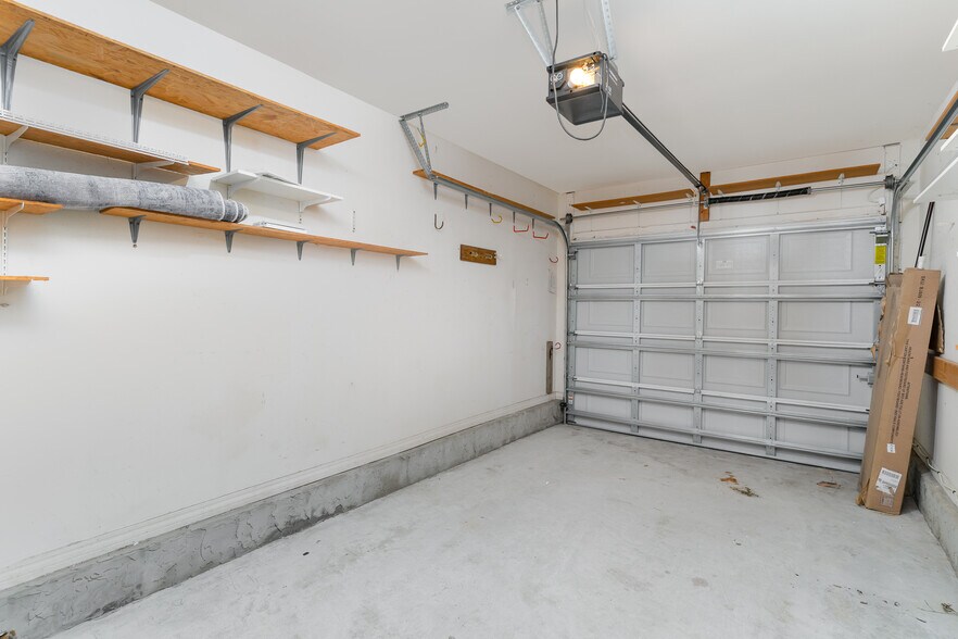 Attached one-car garage with plenty of shelves for storage. - 6464 Starfish Cv
