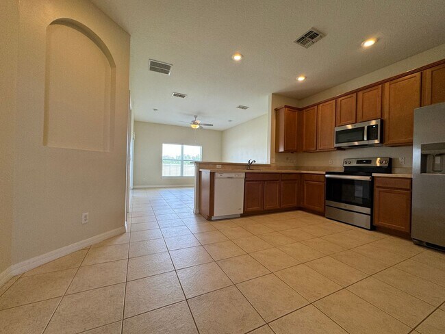 Building Photo - Beautiful 3/2 home near Lake Nona ~ Fenced In Yard ~ LVP & Tile Flooring ~ Community Pool!