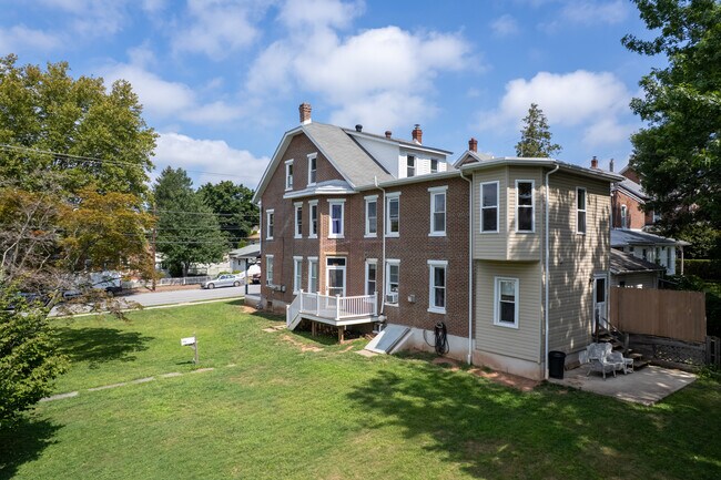 Back of the side yard showing the first floor tenants porch and back entrance. - 506 Washington St