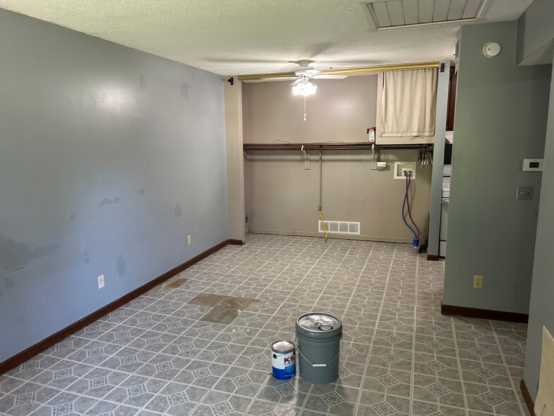 Living room, dining area, laundry hookups (new carpet/flooring and paint coming) - 161 Oak Hill Cluster