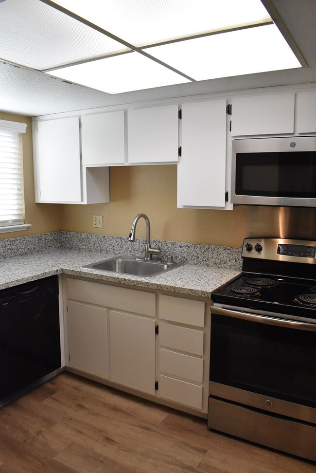 Building Photo - Condo unit featuring updated kitchen with ...