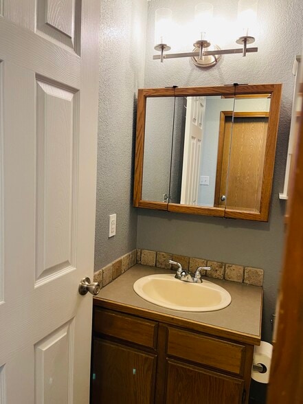 Bathroom sink with 3 mirrors - 906 N 34th Ave