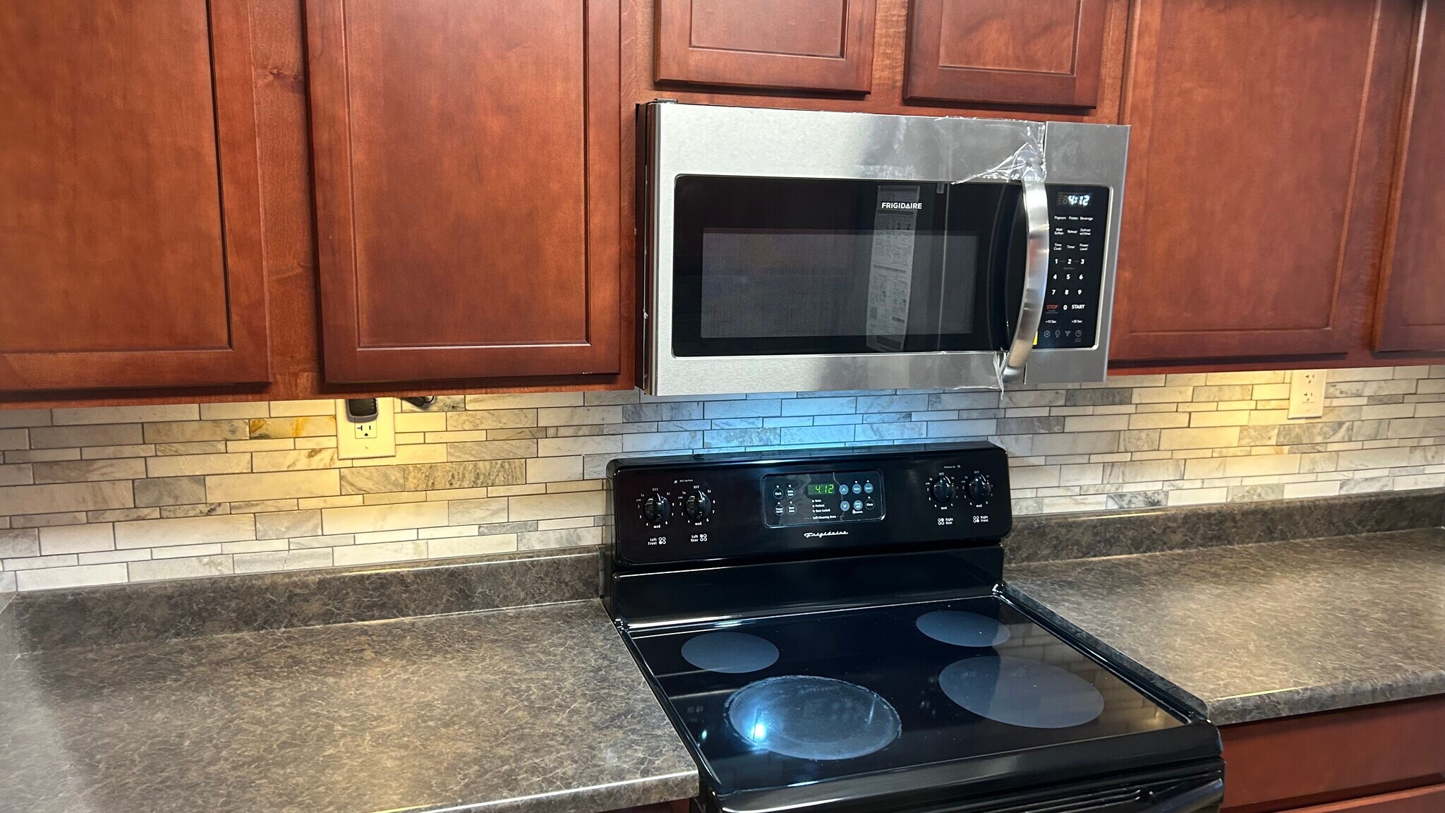 New microwave, backsplash and under counter lights. - 3825 E Camelback Rd