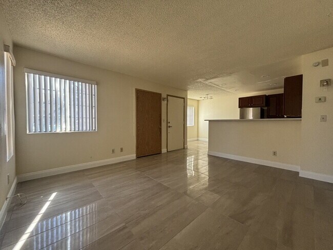 Building Photo - Downstairs 2BR/1BA—recently updated with new flooring, new countertops, and clean, neutral finishes.