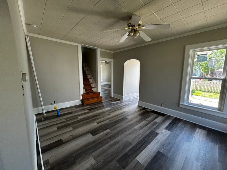 Living room looking at main floor bedroom and stairs - 420 E 2nd Ave