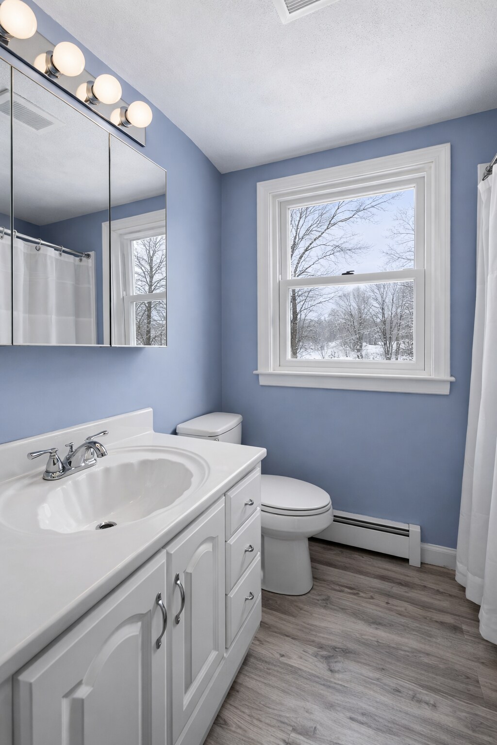 Bright full bathroom with natural light and a tub/shower - 16 Miller Rd