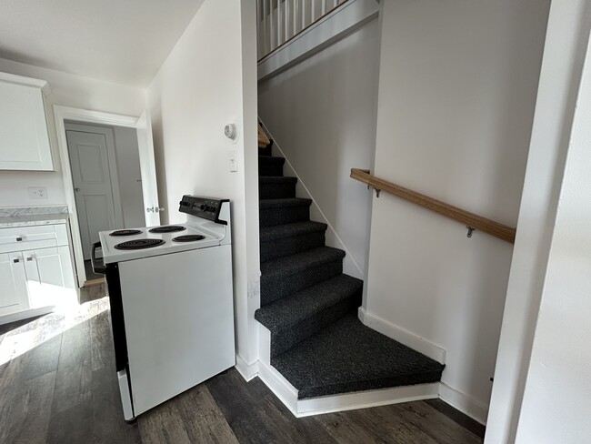 Stairway off kitchen to bedroom and bonus room. - 10 Everett St