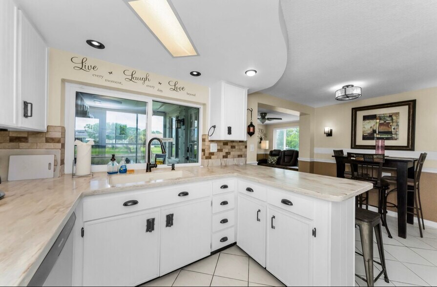Kitchen area with 4 seating bar area. Canal water view!!! - 3931 Sail Dr