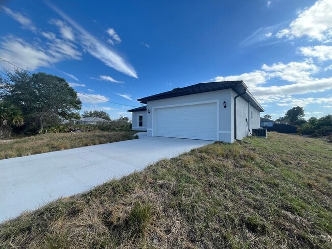 Building Photo - Brand-New 4BR/2BA Luxury Home with 2-Car Garage – Desirable 33971 Location