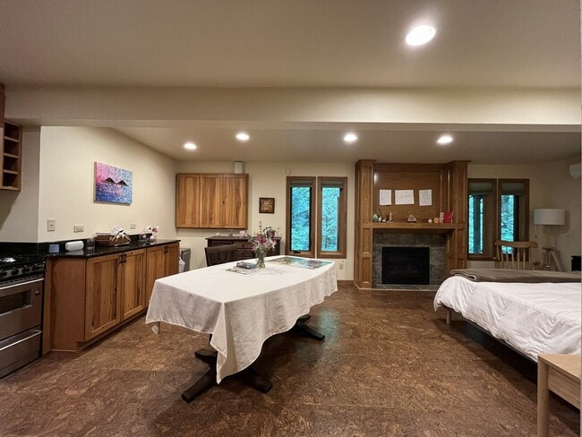 Building Photo - One-of-a-Kind Custom Home with Wall of Windows, Stone Fireplaces, Expansive Entertainment Space &...