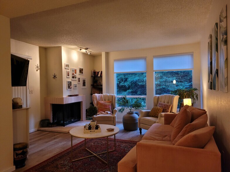 Wood burning fireplace in living room, balcony, and beautiful view of trees right outside - 15707 4th Ave S
