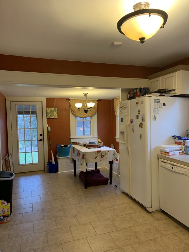 Dining nook in the kitchen with built in bench seating along 2 walls Back door to deck - 704 W Cherokee Dr