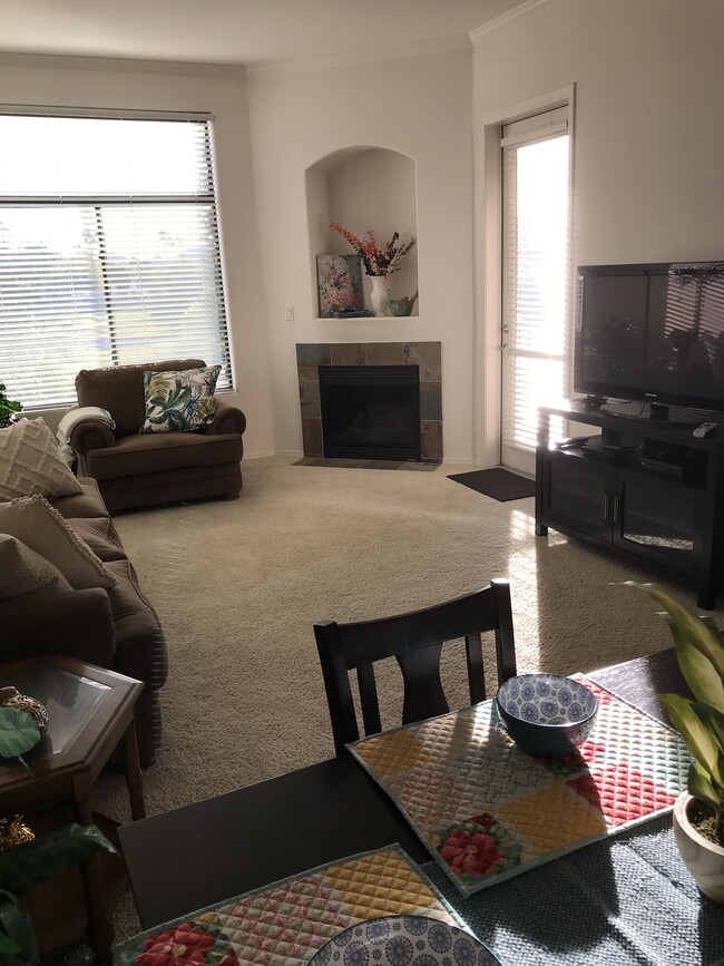 Living room with TV, fireplace & access to the balcony/patio area - 11640 N Tatum Blvd