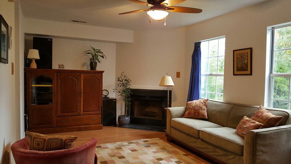 living room with fireplace and ceiling fan - 433 Riverside Ave