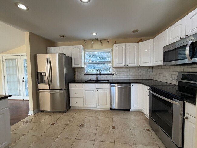 Building Photo - Freshly Painted Split-Level Home with Large Deck & Lawn Care Included