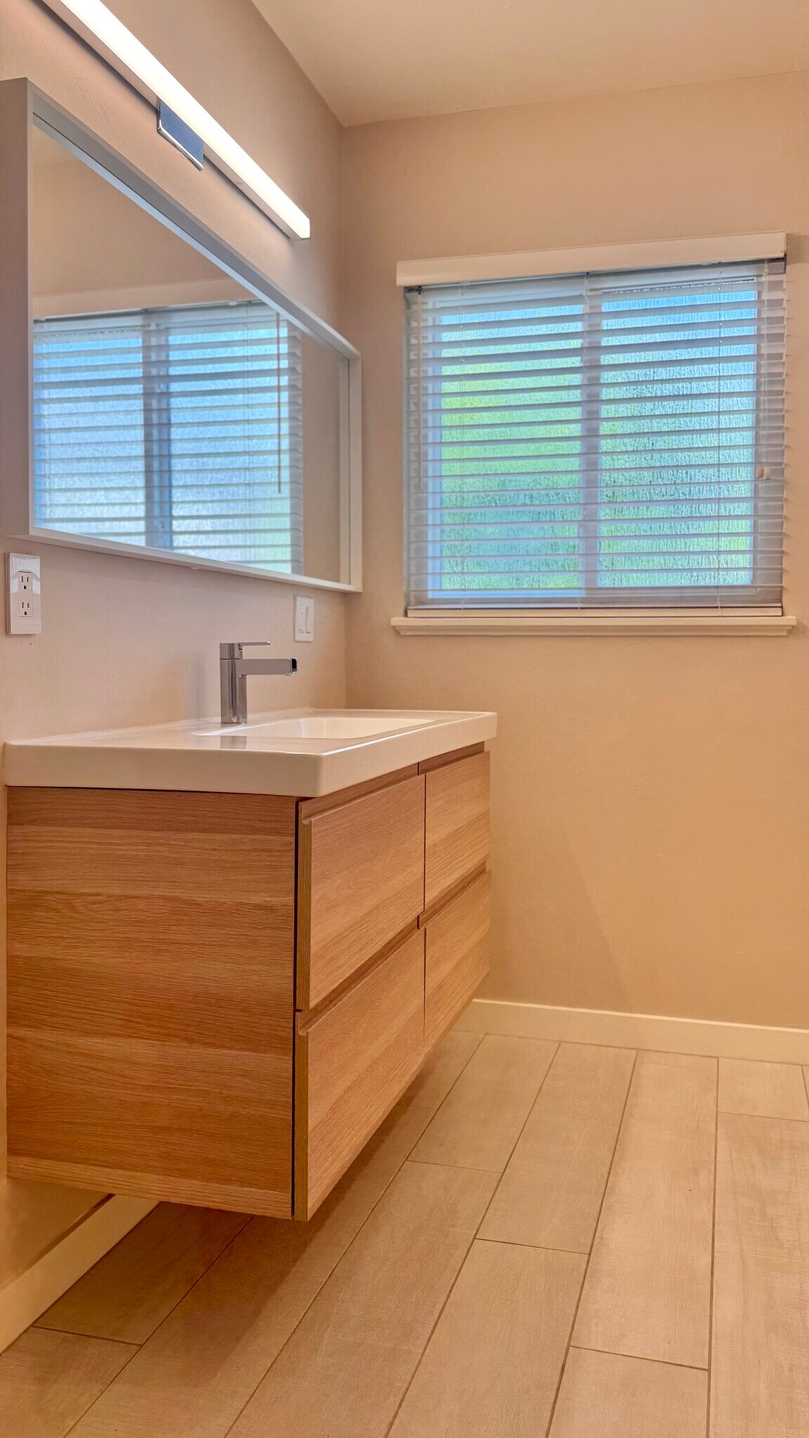 ...as well as bright lighting, Italian ceramic tile floors, and a modern floating vanity. - 2403 Mira Vista Dr