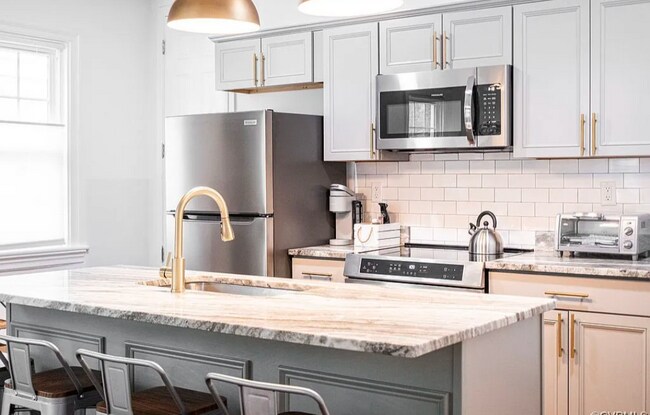 Open concept kitchen with dishwasher, oven, microwave, fridge and not pictured a standalone pantry f - 309 E Brookland Park Blvd
