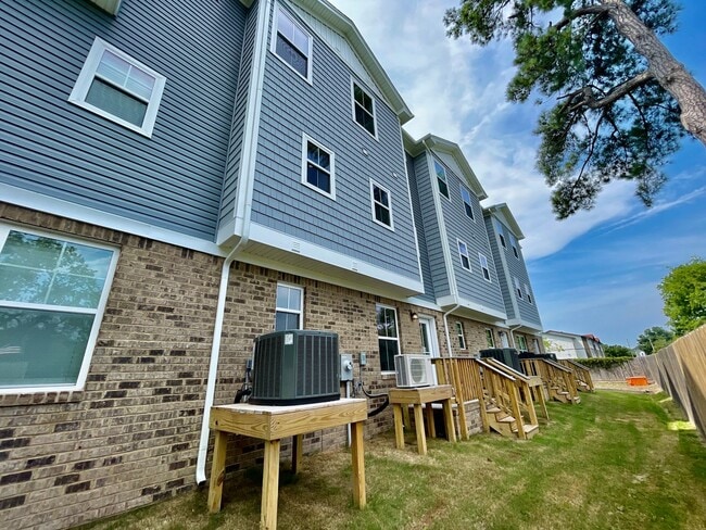 Building Photo - Practically New & Available NOW! Americana Luxury Townhomes! Pet Friendly! Attached Garage! All A...