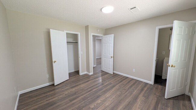 Building Photo - Fenced Yard, Lots of Light, Hard Floors Throughout