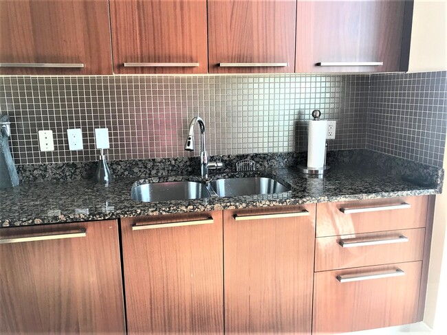 Kitchen with European Cabinetry and crystal chandeliers - 15901 Collins Ave