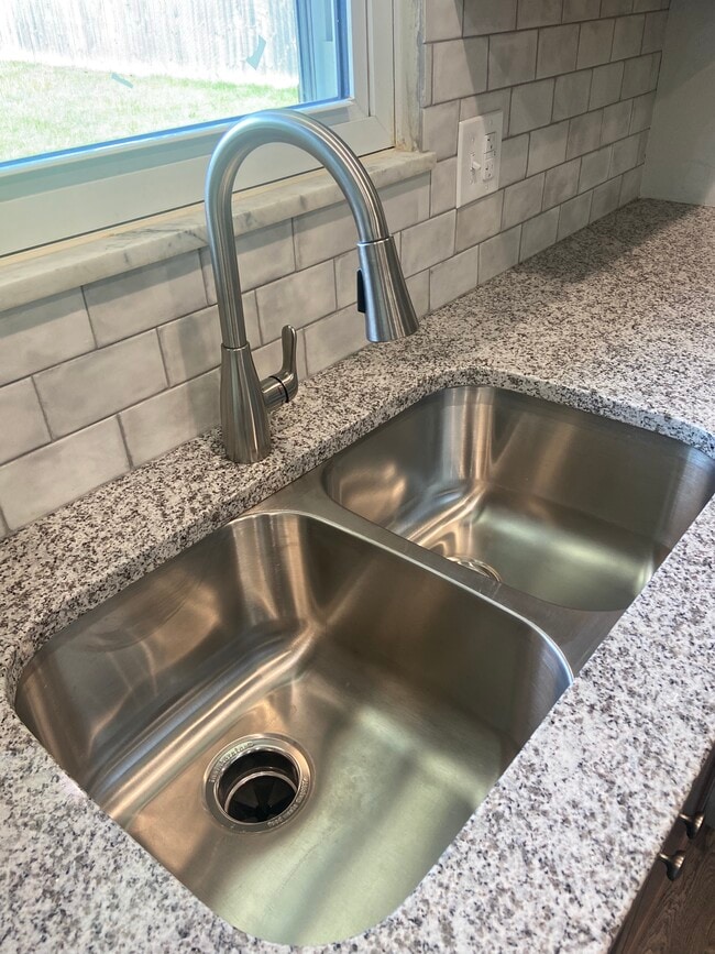 Remodeled Kitchen with granite counters, tile backsplash, and new appliances - 174 Brisbane Ave
