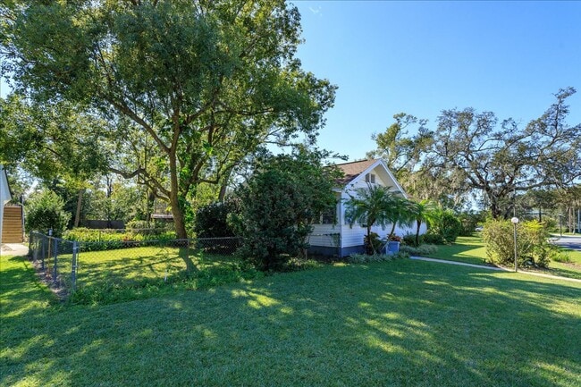 Building Photo - Run don't walk for this one of a kind beautifully maintained Old Florida Charmer on a park like d...