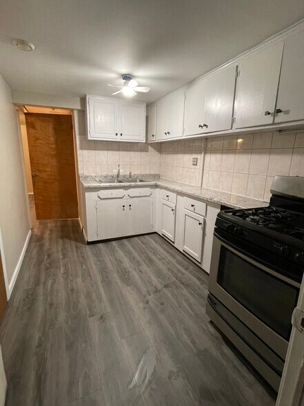 Kitchen with Wood Cabinets and Gas Stove - 3708 W Dickens Ave