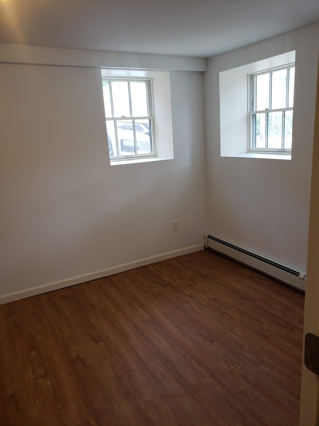 Bedroom. Measures approx 15 ft x 10 ft. Two closets. Three windows. - 2 Judson St