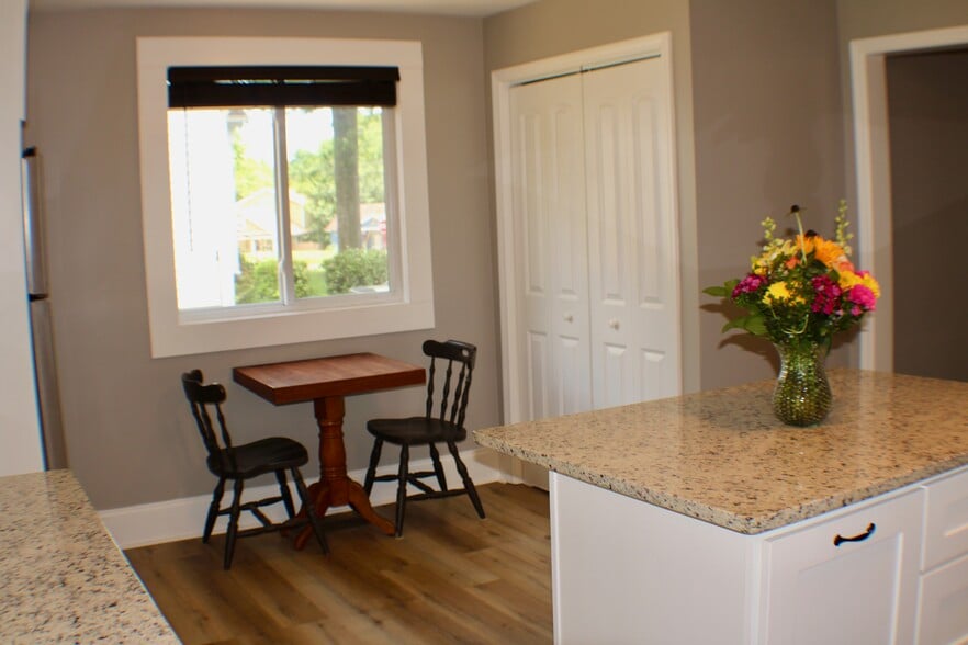 Pantry closet with doors closed in kitchen with table and chairs (table/chairs not included) - 311 Paris Mountain Ave