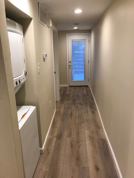 Hallway to bedrooms and bath. Washer/dryer - 1448 Newton St NW