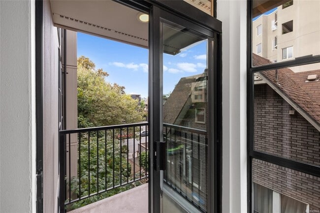 French doors lead to balcony off living room, just the size for al fresco dinner for two - 730 Bellevue Ave E