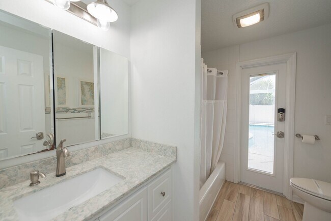 Building Photo - Live the ultimate Space Coast waterfront lifestyle at this stunning beachside canal home in Satel...