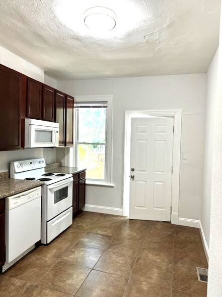 Kitchen with door to backyard and parking - 4229 Shenandoah Ave