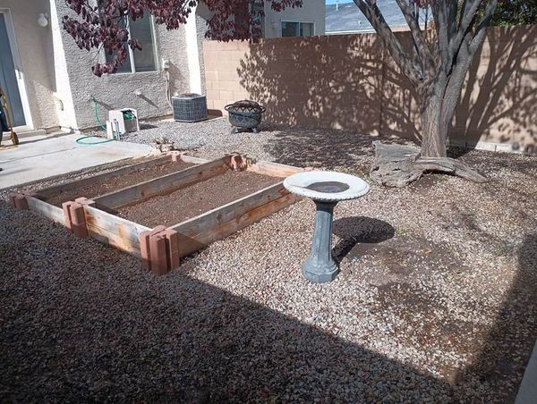 backyard, gravel with planter boxes, birdbath and firepit. - 6501 San Antonio Dr NE
