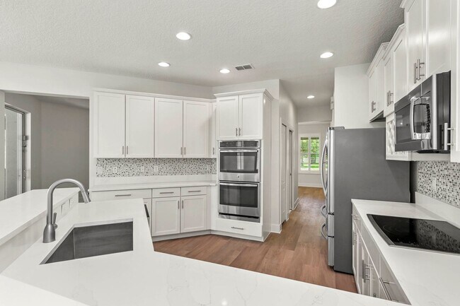 Building Photo - Expansive 4 bedroom, 3 bath remodeled home in gated community