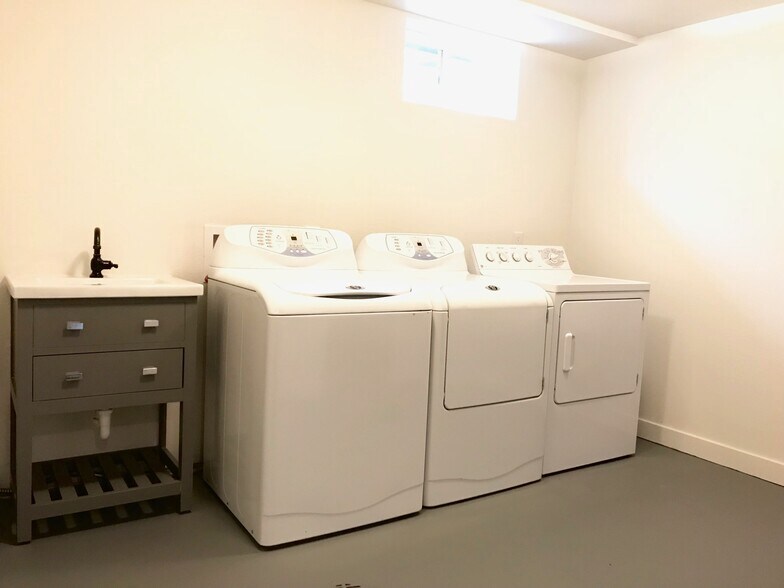Washer Dryer and sink in Utility room with lots of storage space and shelving. - 3360 ward road