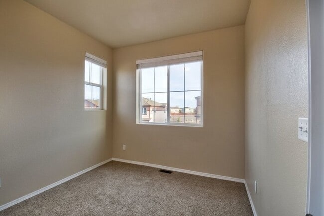 Building Photo - Immaculate 3-Bedroom Townhome with Stainless Steel Appliances and Attached Garage Near Peterson SFB