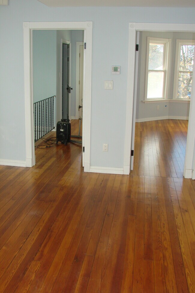 Dining room view showing doors to hallway, front entry and living room entry - 713 Orchard St