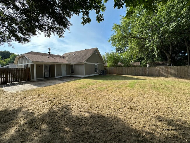 Building Photo - Charming 3BR/2BA Near Southwind | Soaring Vaulted Ceilings, Brick Fireplace & Fenced Yard
