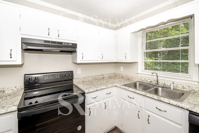 Building Photo - Welcome to this charming abode.